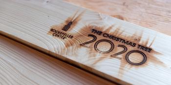 Closeup of wood branded with Rockefeller Center Christmas Tree 2020.