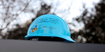 Blue hard hat with butterfly sticker and signed by Habitat CEO Jonathan Reckford with the message "Thank you for blessing the world with your compassion and commitment to service"