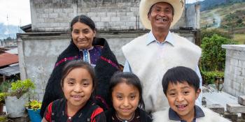 Camilo with his wife and three kids in front of their cement block Habitat home in picturesque Chiapas, Mexico.