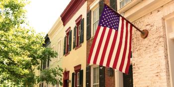 American flag hanging from townhome.