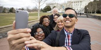 Advocates take a group selfie in front of the Capitol building in Washington, D.C.