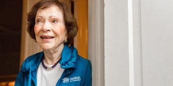 Rosalynn Carter wearing a blue Habitat for Humanity jacket and smiling