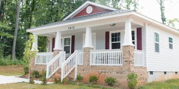 Craftsman style Habitat home with nice lanscaping and porch.