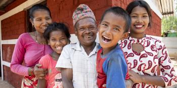 The Danuwar family of five, pictured smiling here, partnered with Habitat for Humanity Nepal to rebuild the home they lost during the 2015 Nepal earthquake.