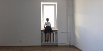 young girl looking out window.