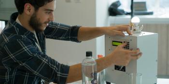 Man demonstrating electronic prototype.