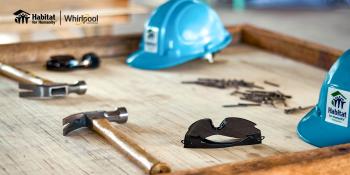 close-up of tools and Habitat branded hard hats