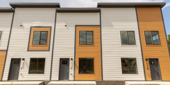 Row of modern yellow townhomes