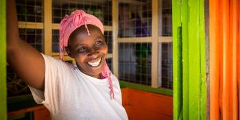 Woman smiles in her home.