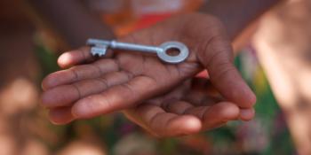 Child's hands holding a key.