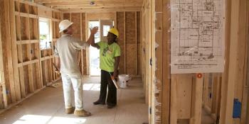 Volunteers high fiving on build site