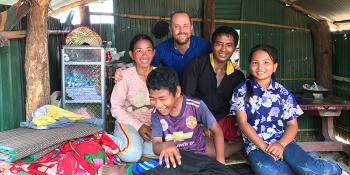 Dan Peyton (back, center) with a Cambodian family whom he worked with to build their new home