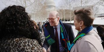Jonathan Reckford greets participants of Habitat on the Hill, with the Capitol visible in the background.