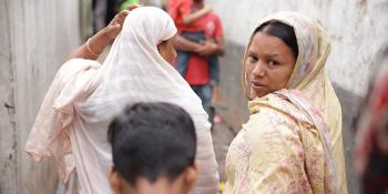 Sumi walking with other residents of Duaripara informal settlement