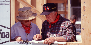 The Carters standing together on the build site.