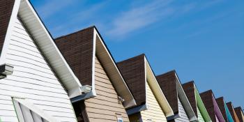 Row of colorful Habitat homes against a blue sky.