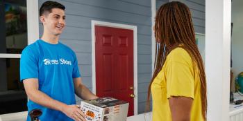 Volunteer and ReStore customer at register.