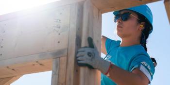 A volunteer works on a wall at the Carter Work Project build site.