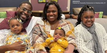 Jermonte, Erica and their three daughters posing on a sofa