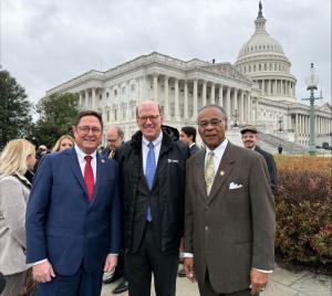 Three men in stand in front of the U.S. Capitol. From left to right, Mike Flood, Jonathan Reckford and Emanuel Cleaver.