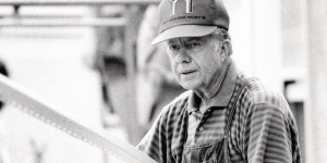 Black and white photo of Jimmy Carter working during the 1988 Carter Work Project.