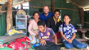 Dan Peyton (back, center) with a Cambodian family whom he worked with to build their new home