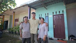 Hendra, son Santo and wife Erta outside their home in Batam, Indonesia