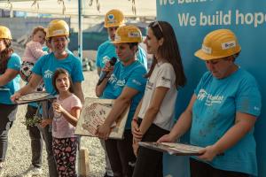 Beneficiary speaking at the end of a Hope Build in Romania