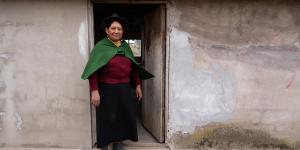 A woman standing in the doorway of her home.