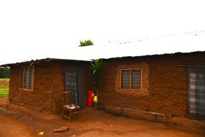 picture of a mud home with netting on windows and doors