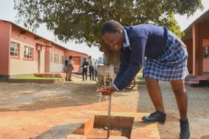 school girl washes her hands