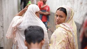 Sumi walking with other residents of Duaripara informal settlement