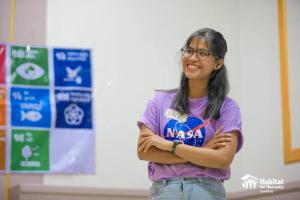 Volunteer trainer Kannika Nhem smiling with arms crossed