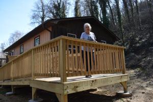 Homeowner stands on new wooden ramp