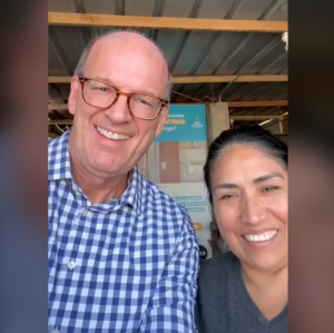 Jonathan Reckford and a woman smile in a selfie.