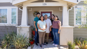 Family in front of house.