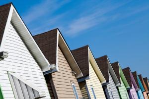 Row of colorful Habitat homes against a blue sky.
