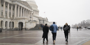 Chris Vincent, Jonathan Reckford and Jessica Anderson make their way to meetings with congressional representatives at the Capitol.