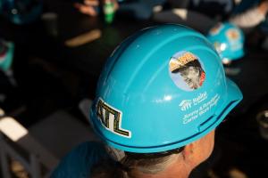 Overhead shot of a volunteer wearing a blue Habitat hard hat with a large "ATL" sticker on the back and a sticker of Jimmy Carter on the side. 