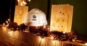 A mantel decorated with string lights and a Habitat hard hat