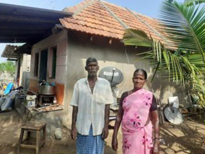 Couple standing in front of home