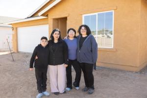 Family in front of house.