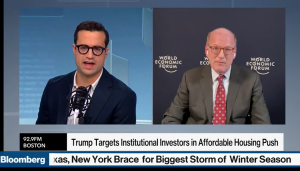 Split screen image of two men, with Jonathan Reckford (right) being interviewed on Bloomberg Live.
