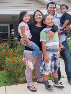 smiling homeowner family with children.