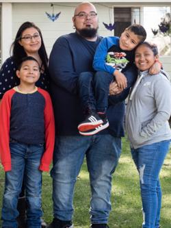 Family of five in front of their Habitat home.