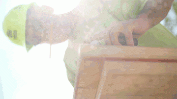 Habitat for Humanity volunteer sawing wood