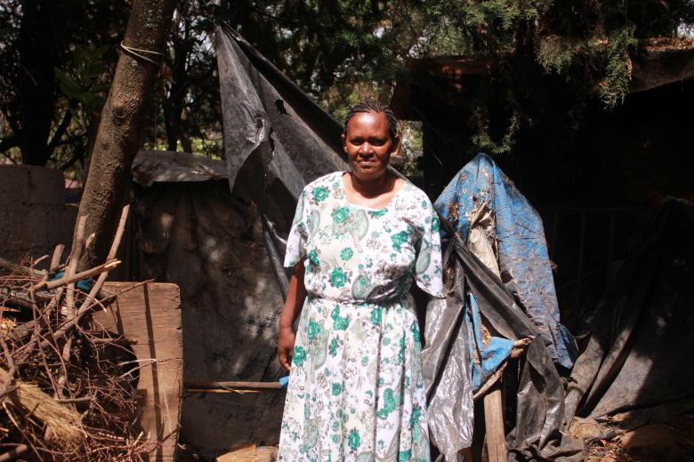 Fikirte in front of her toilet