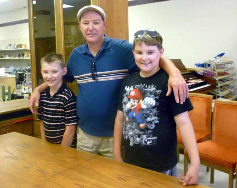 Chris and sons with their ReStore dining set
