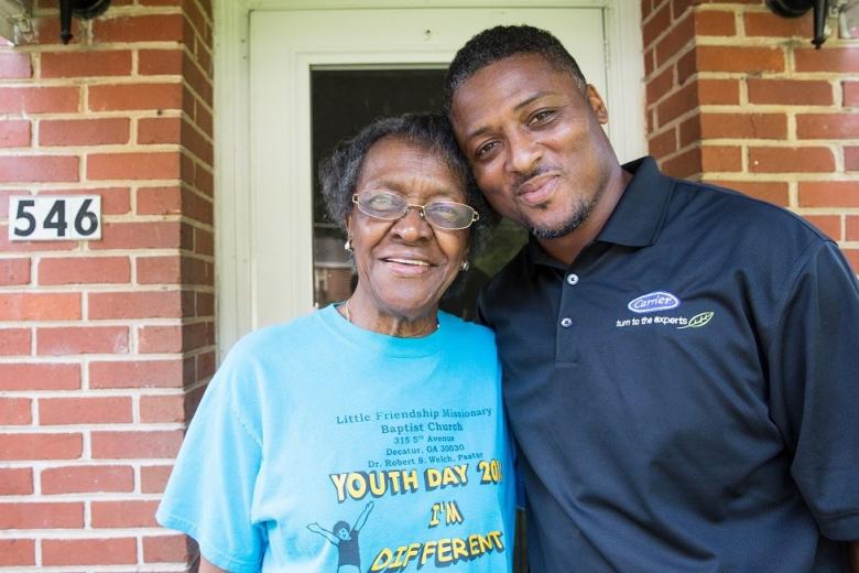 NFL Pro Bowler and longtime Habitat supporter, Warrick Dunn, joins Atlanta homeowner, Ms. Ruby, to celebrate the installation of a Carrier ductless home comfort systems in her home, one of more than 500 donated to Habitat for Humanity this year.