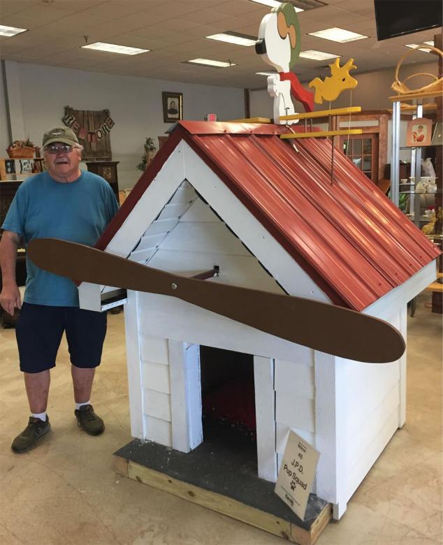 Snoopy doghouse, complete with a wooden Snoopy and Woodstock.